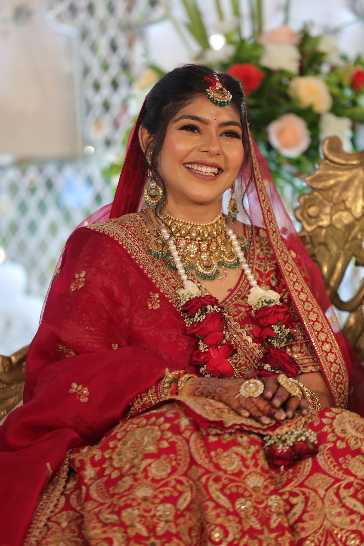Bride smiling in traditional red wedding attire