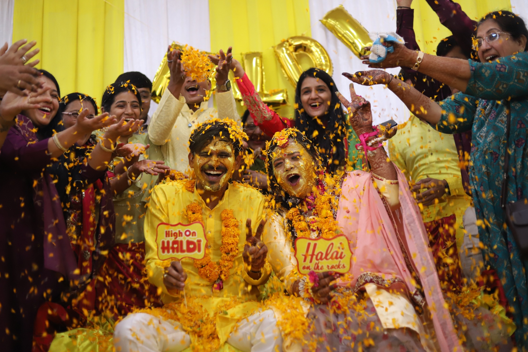 Couple celebrating a joyful haldi ceremony